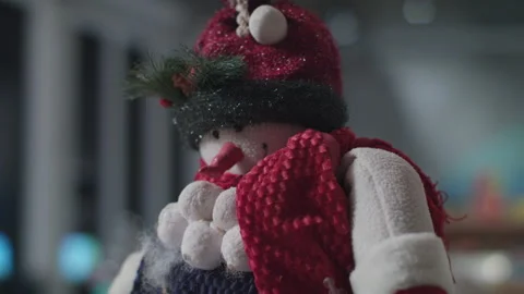 A snowman with a carrot nose gets placed for the christmas holiday season Stock Footage 137913264