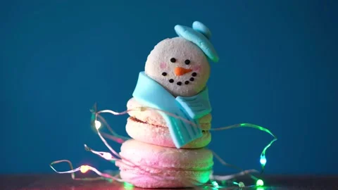 Snowman dessert macaron decorated with hat and scarf wrapped with colorful 스톡 동영상 255922446