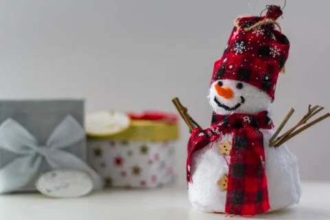 Snowman with gift boxes on the background Stock Photos