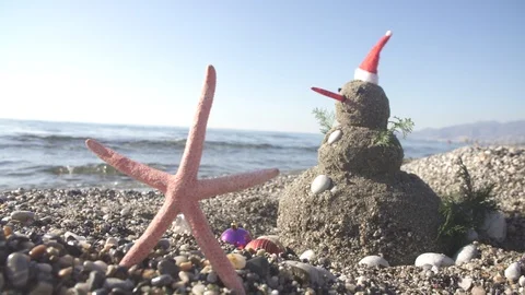 Snowman on holidays made of sand instead of snow. Concept tropical resort Video stock 121740501