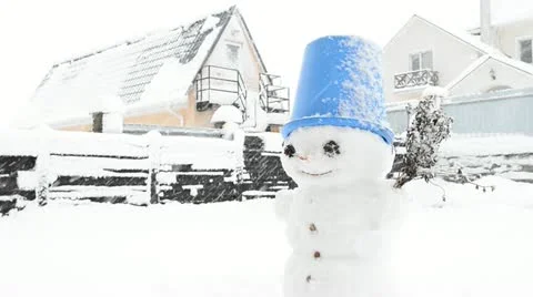 Snowman.  Motion picture of snowman in cold winter day and snowfall. Stock Footage 22008072