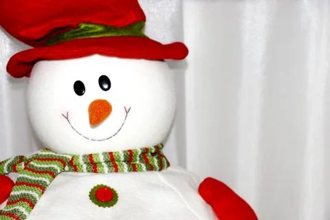 Snowman toy in a red hat close-up on white background Stock Photos