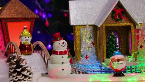 Snowmen in front of a rotating house in a Christmas town 库存影片 346149032