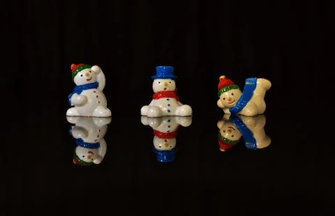 Snowmen with reflected image Stock Photos