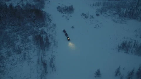 A snowmobile is dragging two cart-sleds Stock Footage 87371442