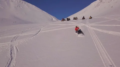 Snowmobile driver makes circle trace on white smooth snow Stock Footage 112536611