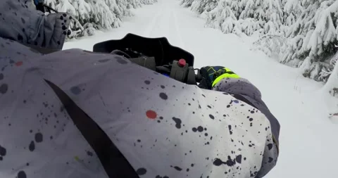 Snowmobile man navigating Winter Forest Trail Through Pristine Snow Covered L Stock Footage 323389775
