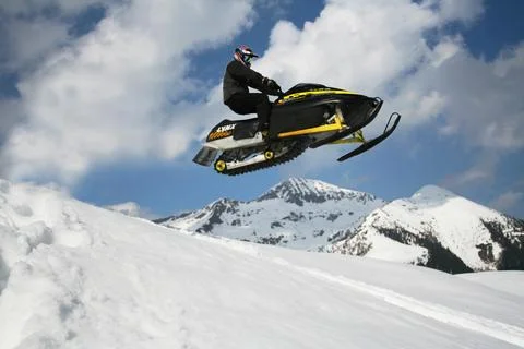 Snowmobile in the mountains Stock Photos