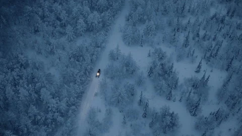 A snowmobile is moving on a path through the woods Stock Footage 87373114