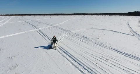 Snowmobile rides on the field Stock Footage 86991911