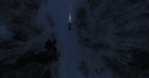 Snowmobile rides through the forest at night Stock Footage 89641198