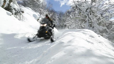 Snowmobile riding snowy mountain road Stock Footage