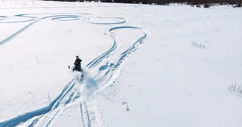 Snowmobile rushes through the field Stock Footage 87837548