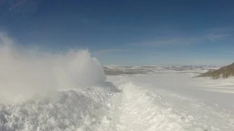Snowmobile snow flying into camera HD Stock Footage 10797344