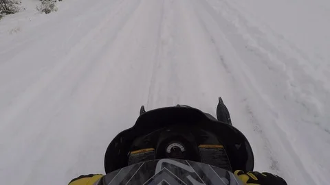 Snowmobile winter recreation ride snow covered trail HD Stock Footage