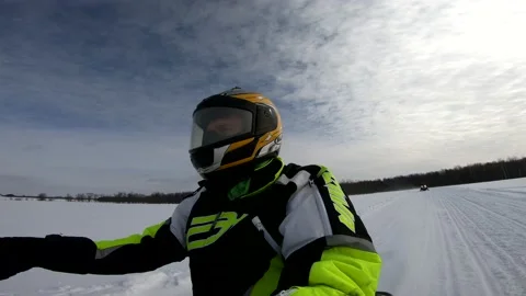 Snowmobiling Man Through an Open Field Video stock 130214661