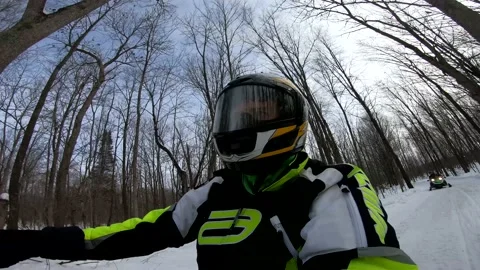 Snowmobiling Man in Woods Emerging into an Open Field Stock-Footage 130213618