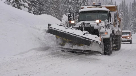 Snowplow at Work Clearing a Winter Road, BC, Canada, Jan 2023 Stock Footage 253121519