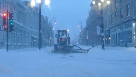 Snowplower passing in the street Stock Footage 103870366