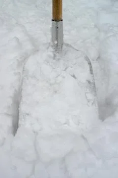 Snowshovel in a deep snow Stock Photos