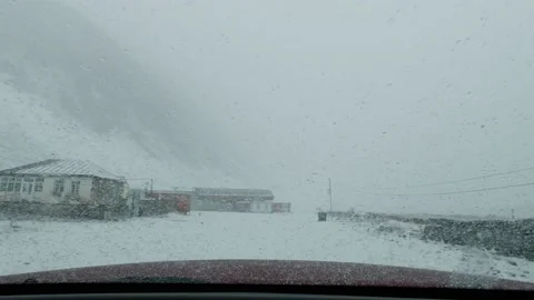 Snowstorm caused a long queue of stranded delivery trucks along a snowy Stock Footage 158275549