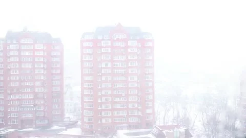 Snowstorm in the city, view from the window at a height of 4k video Stock Footage 148585259