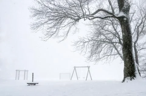 Snowstorm over an empty playground Stock Photos