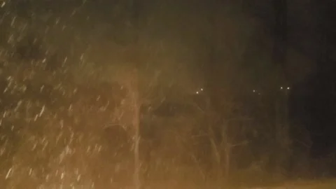 Snowstorm seen from an upstairs window at night Stock Footage