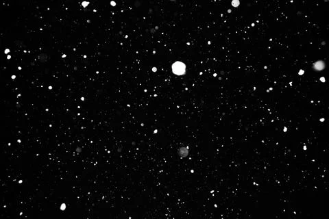 Snowstorm texture on a black background. Stock Photos