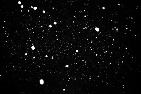 Snowstorm texture on a black background. Stock Photos