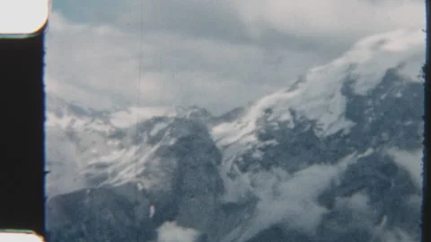 Snowy Alpine Landscape Under Cloudy Skies Stock Footage 322132667
