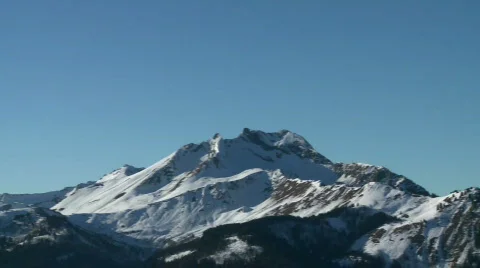 Snowy alpine mountain pan Stock Footage 303369