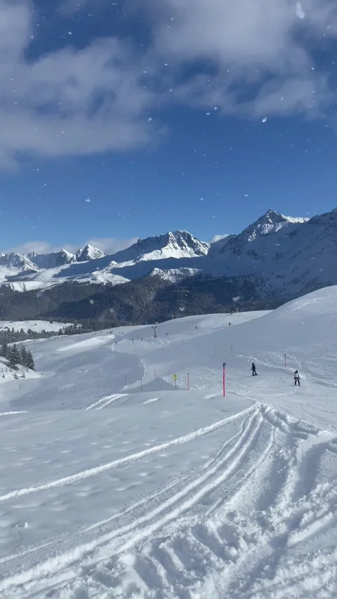 Snowy alpine peaks under a blue sky and clouds in Switzerland Video stock 330585225