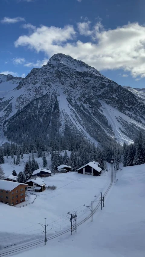 Snowy alpine peaks under a blue sky with Swiss chalets in Switzerland. Video stock 330585227