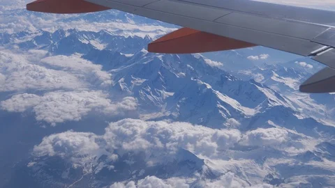 Snowy Alps mountain range under airplane wing Stock Footage 106947982