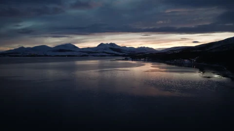 Snowy Arctic Mountains Beyond a Calm Norwegian Fjord at Blue Hour Stock Footage 337712918
