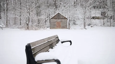 Snowy Bench in Rustic Winter Scene Stock Footage 129714378