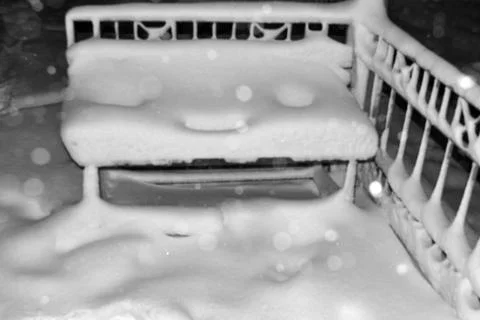 Snowy Bench With Snow Falling Stock Photos