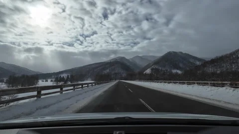 Snowy Bridge over River with Mountains Hokkaido Japan Stock Footage 333369752