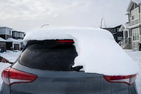Snowy car back window needs clearing on a cold winter morning day. Stock Photos