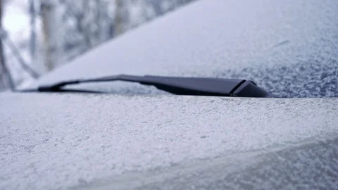 Snowy car front and windshield rack focus shot Stock Footage 102956459