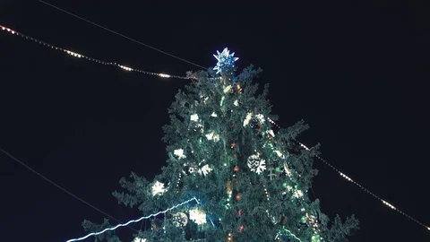 Snowy Christmas tree, decorated with different lights at night. 스톡 동영상 81744849