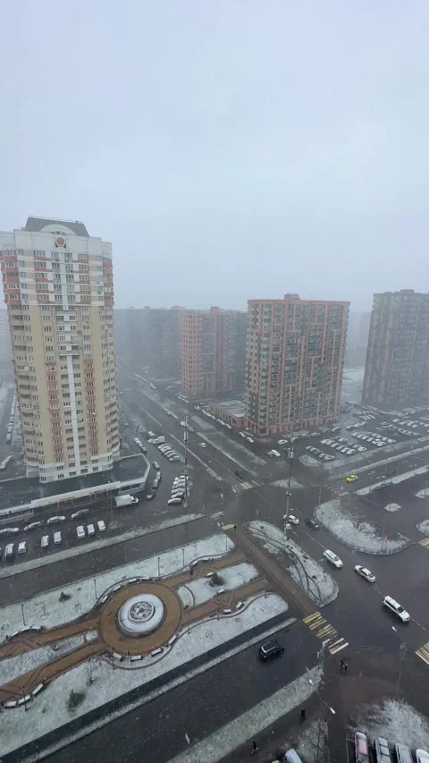 Snowy cityscape view from high building window. Urban residential district with Vídeos de archivo 339432965