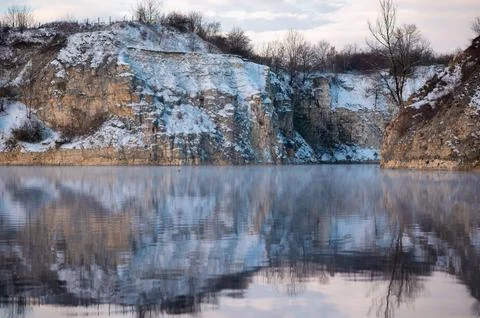 Snowy Cliffs Reflecting in Tranquil Lake Stock Photos