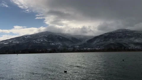 Snowy clouds and stormy snowfall begins in Sapanca lake, fast shooting time l Stock Footage 133654657