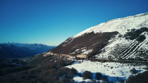 Snowy, cloudy mountains formed by steep cliffs. Peaks that are hard to reach Video stock 170786402