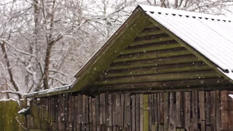 Snowy day. It is snowing against the background of an old small house. Cozy wint Stock Footage 147688922
