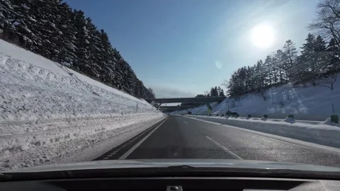 Snowy expressway drive passing multiple bridges with mixed traffic Stock Footage 333229874