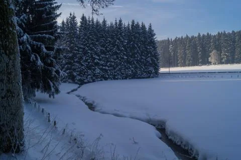 Snowy field with stream Stock Photos