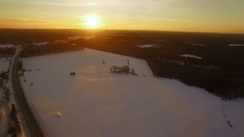 Snowy fields by a small highway during sunset Stock Footage 88204716